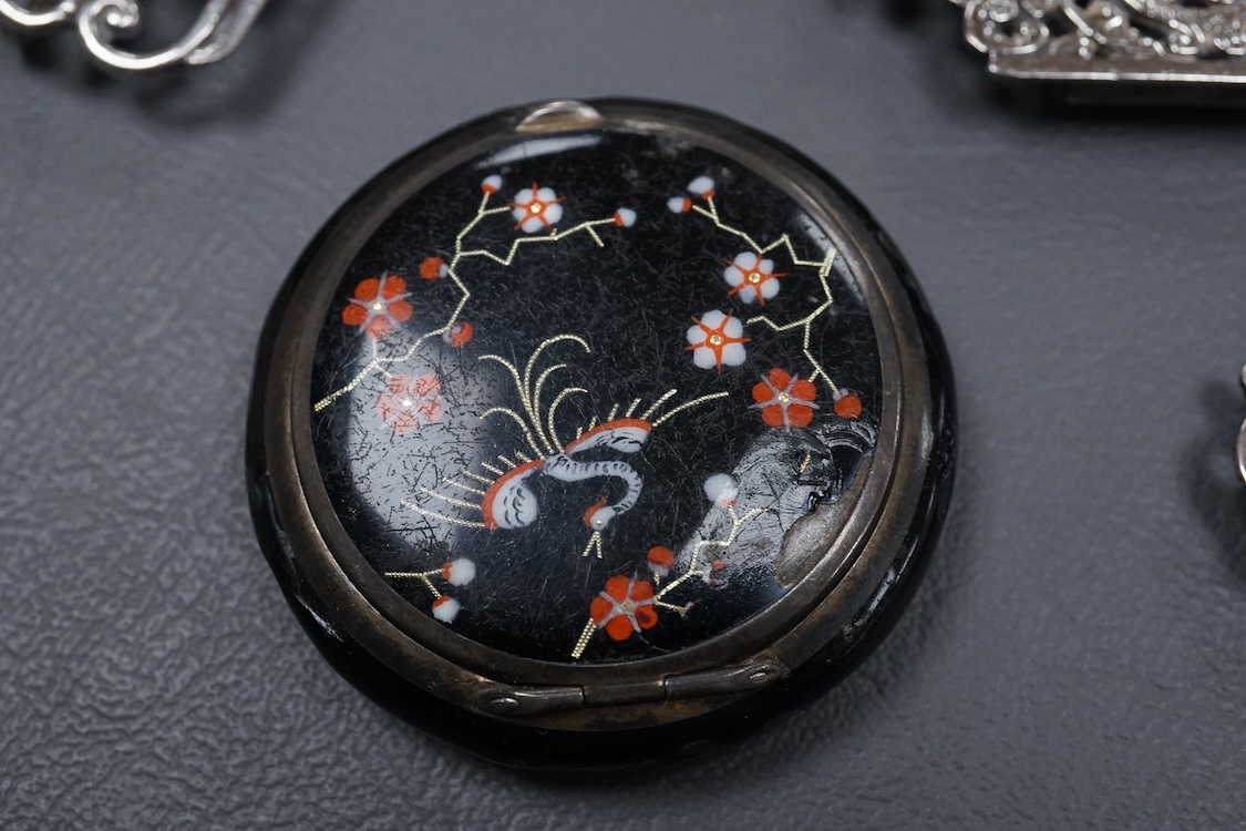 A group of small collectable silver including a white metal dragon menu holder? by Wang Hing, 92mm, two 19th century caddy spoons, three assorted belt buckles and a 1920's silver and enamel pill box(a.f), import marks fo